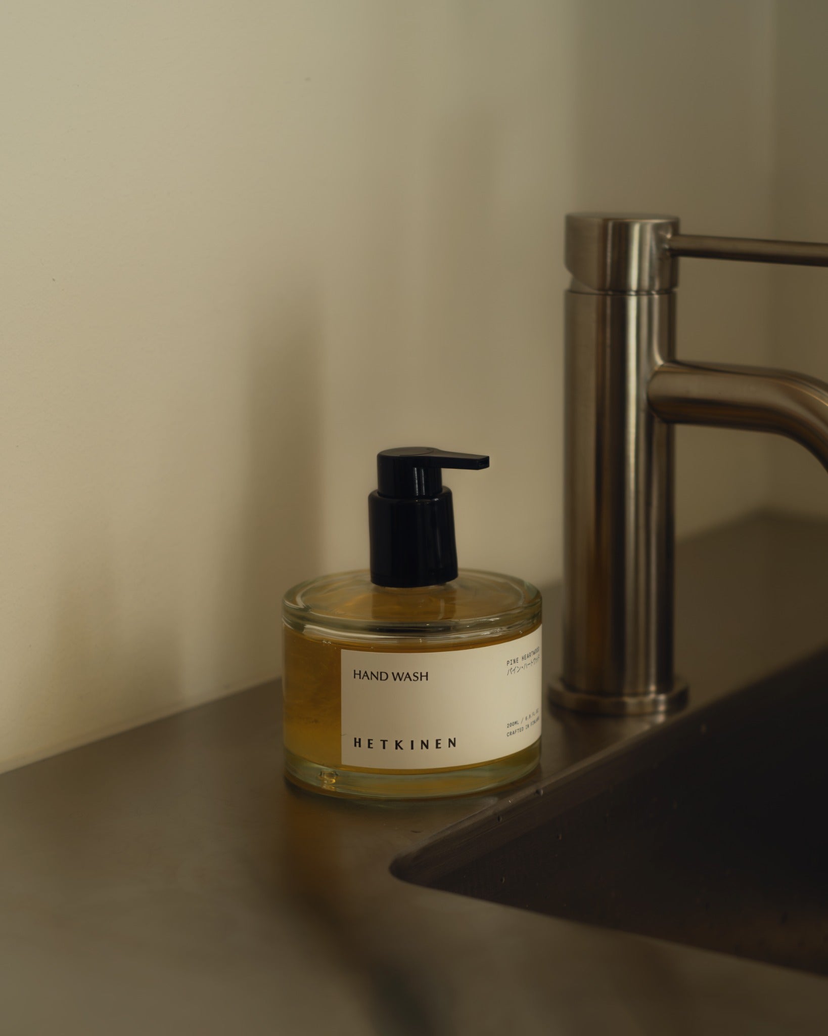 Hetkinen Pine Heartwood hand wash beside a sink